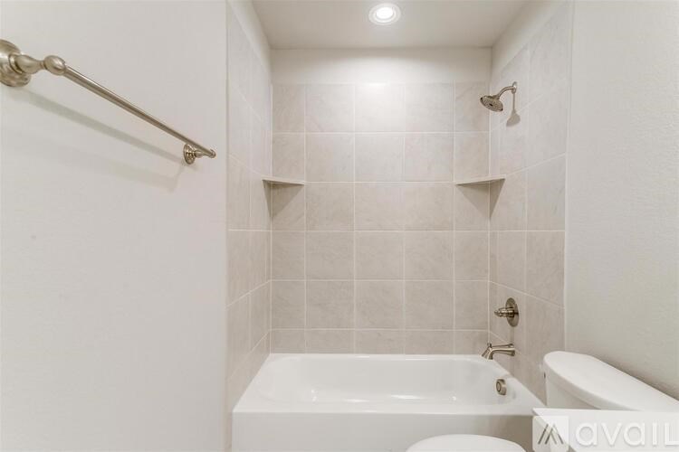 A white bathroom with a tub, toilet, and sink.