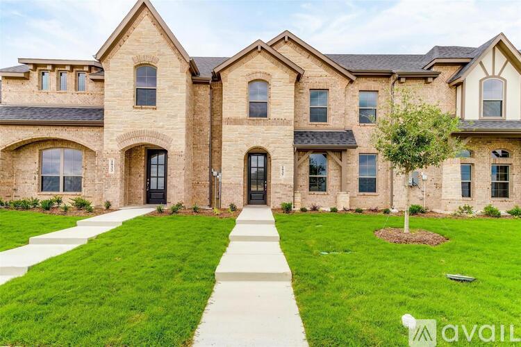 A large, well-maintained house with a brick facade and a front yard.