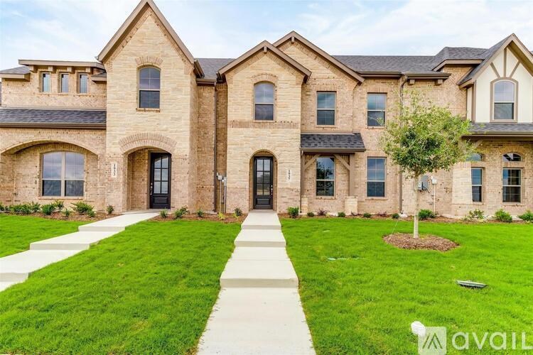 A large, well-maintained house with a brick facade and a front yard.