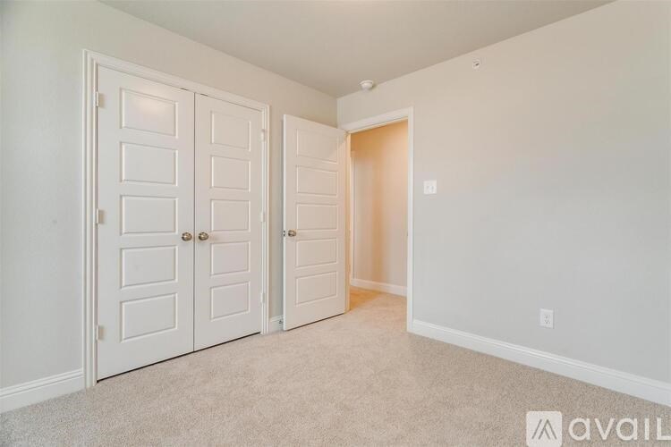 A room with two doors and a carpeted floor.