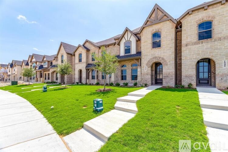 A row of houses with a grassy front yard.