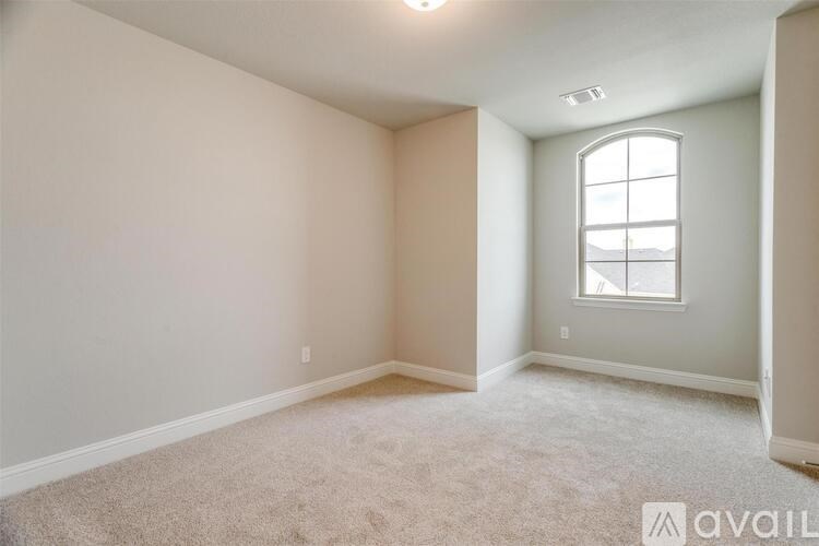 A room with a carpeted floor and a window.