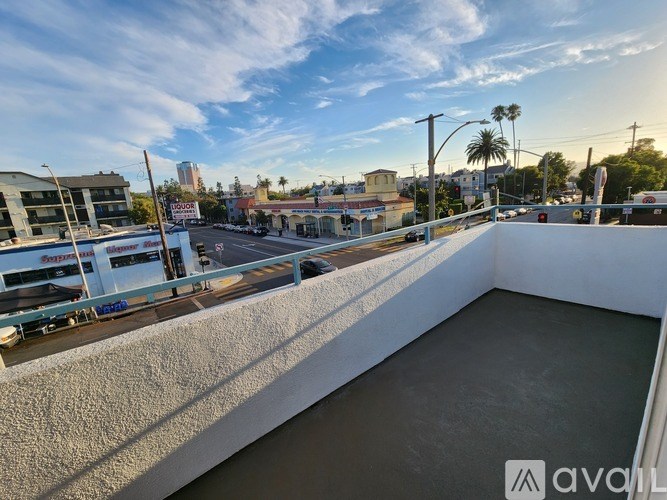 A rooftop with a pool and a view of the city.