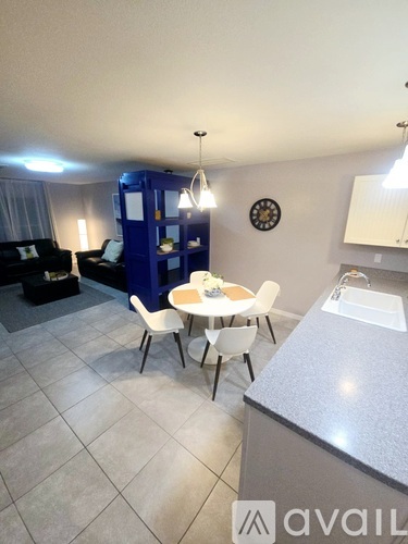 A kitchen with a table and chairs in the middle of the room.