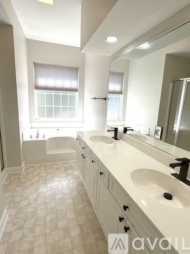 A bathroom with two sinks and a large mirror.