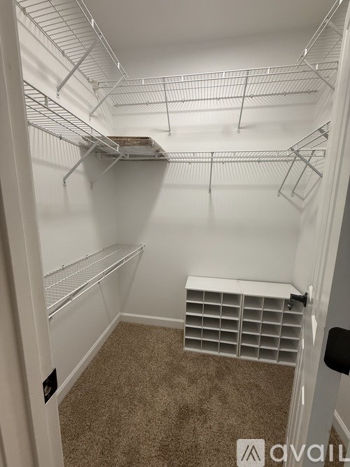 Empty white refrigerator with shelves and a drawer.