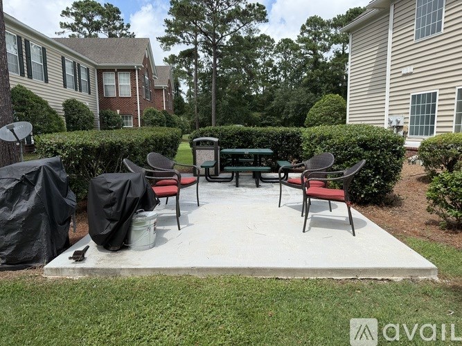 A patio with a table and chairs is covered with a black tarp.