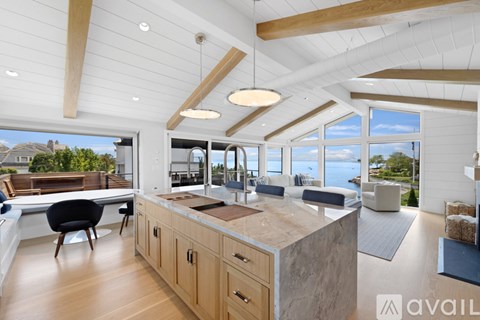 A modern kitchen with wooden cabinets and a large island.
