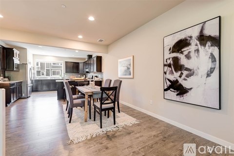 A modern kitchen with a dining table and chairs.