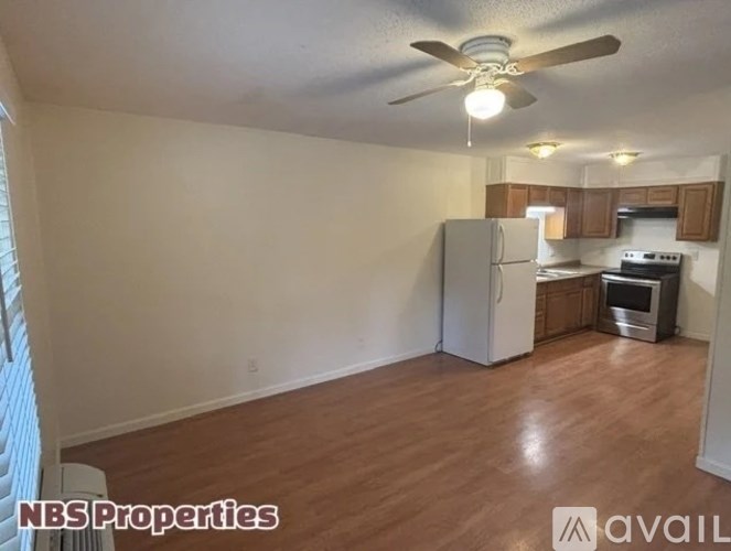 A kitchen with a refrigerator, oven, and microwave.