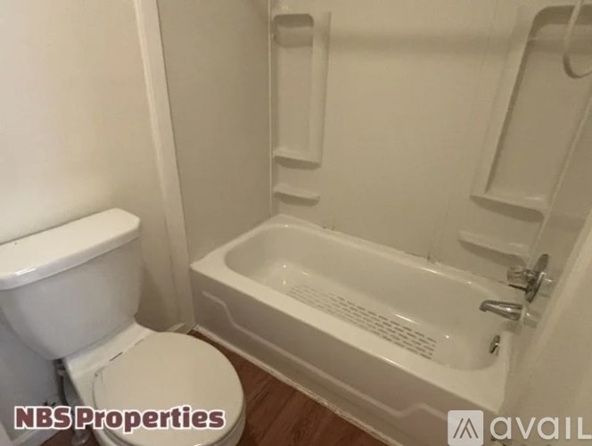 A white toilet and sink in a small bathroom.