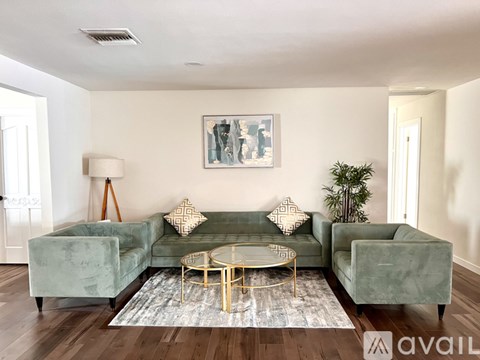 A living room with a green couch and a coffee table.