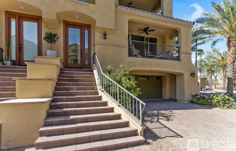 A house with a staircase leading to the front door.