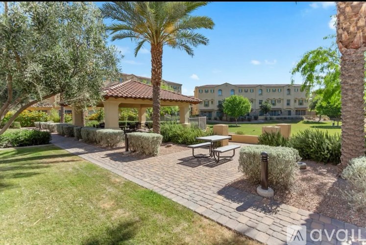 A sunny day at a resort with palm trees and a building in the background.