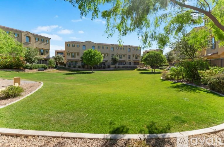 A grassy area in front of apartment buildings.