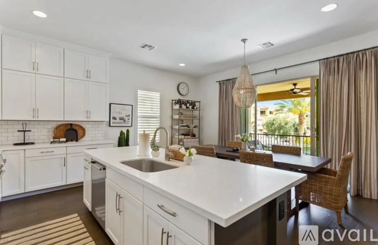A modern kitchen with white cabinets and a large island.