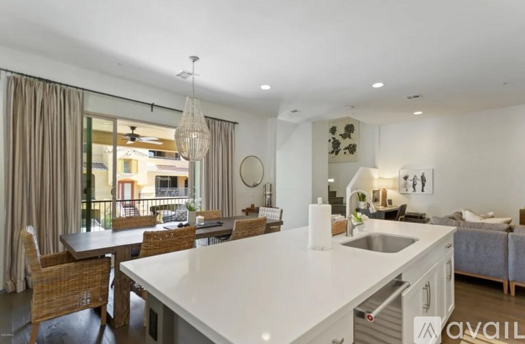 A modern kitchen with a dining table and chairs.