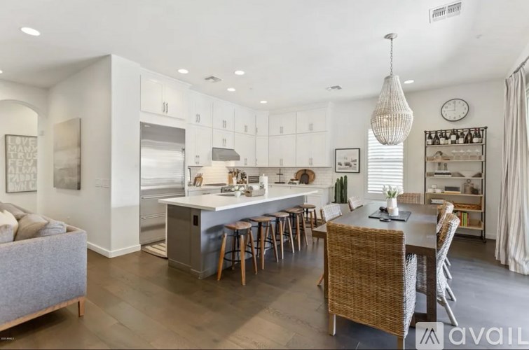 A modern kitchen with a dining area and a living room.