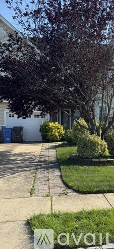 A house with a tree in front of it.