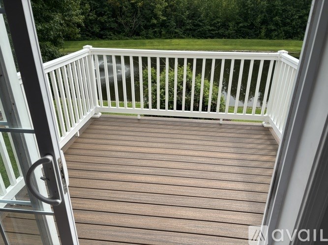 A deck with a white railing and a gate is shown.