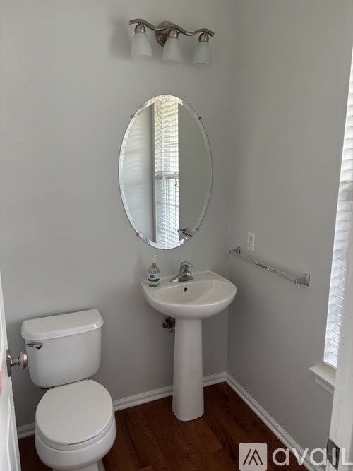 A white toilet and sink in a small bathroom.