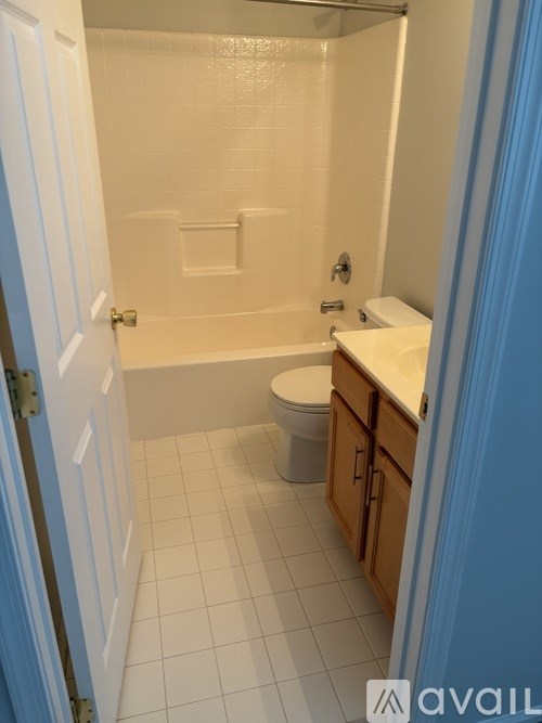 A bathroom with a toilet, sink, and bathtub.