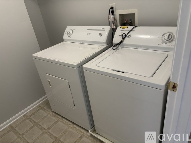 A white washing machine and dryer in a small laundry room.