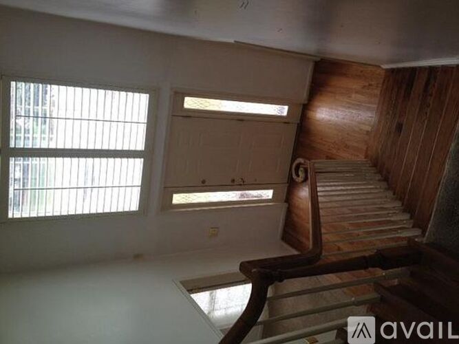 A room with a staircase and a window.