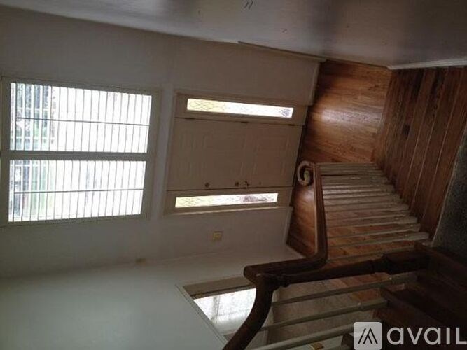 A room with a staircase and a window.