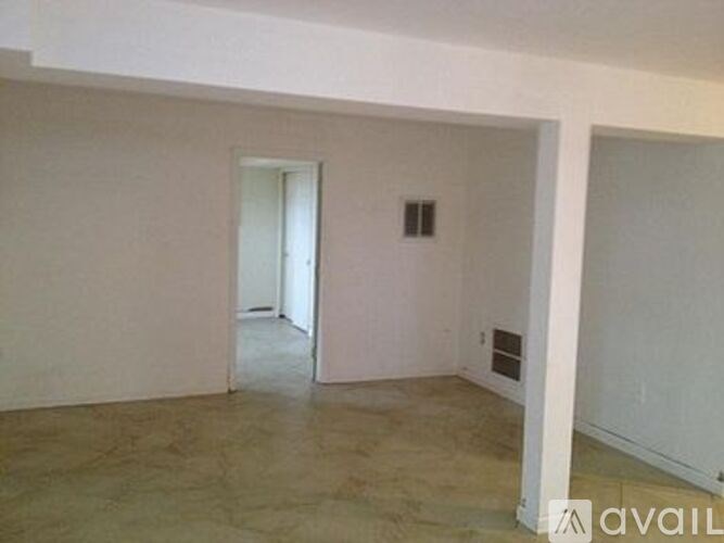 A room with a doorway leading to another room.