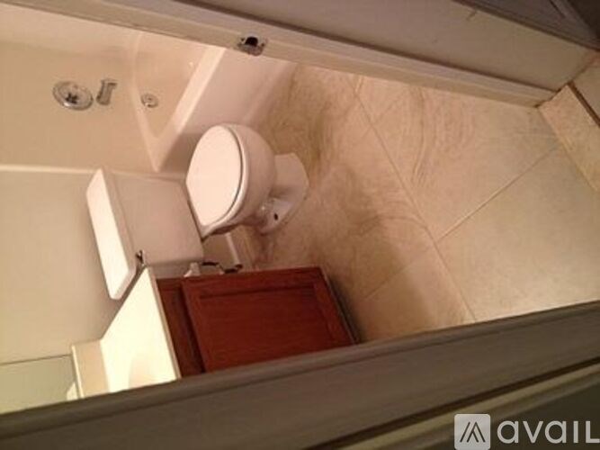 A white toilet is installed in a small bathroom.