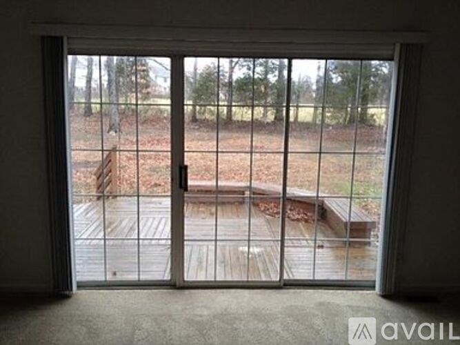 A view of a backyard through a sliding glass door.