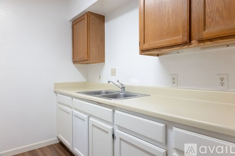 A kitchen with wooden cabinets and a white countertop.