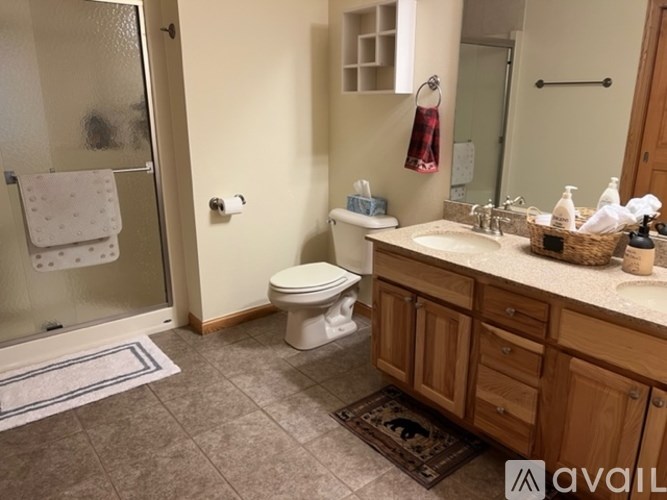 A bathroom with a toilet, sink, and shower.