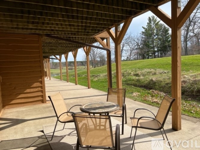 A wooden patio with a table and chairs.