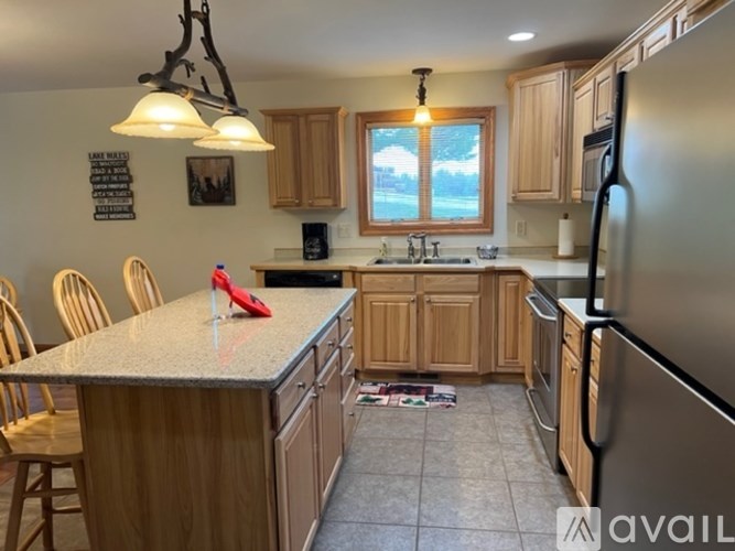 A kitchen with wooden cabinets and a granite countertop.