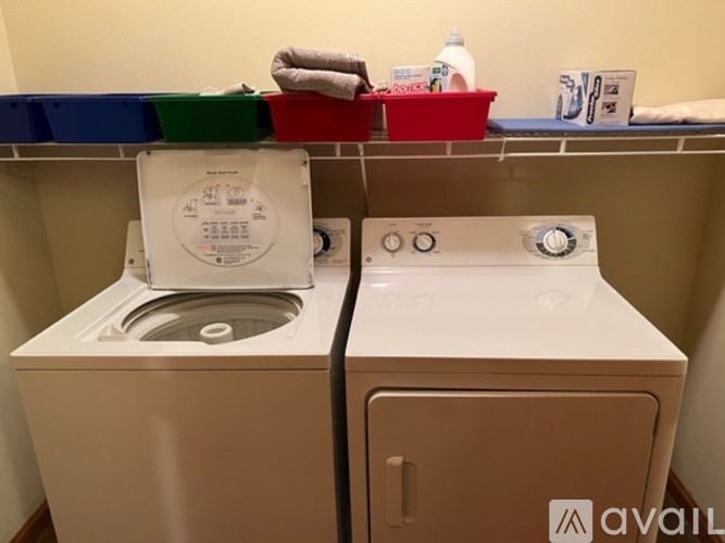 A washing machine and dryer are in a small laundry room.