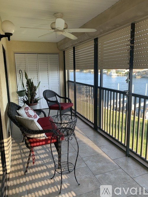 A wooden dock extends into a body of water with a boat tied to it.