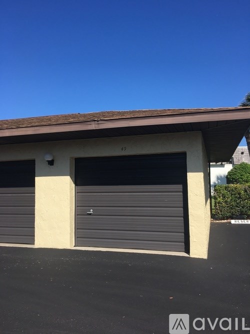 A building with two garage doors and a roof.