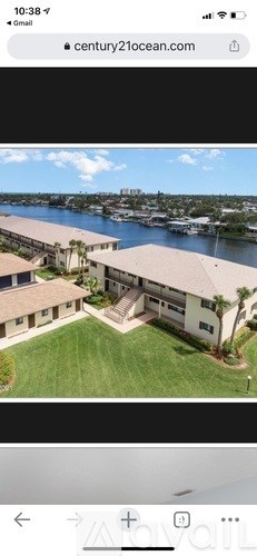A large building with a green lawn in front is visible.