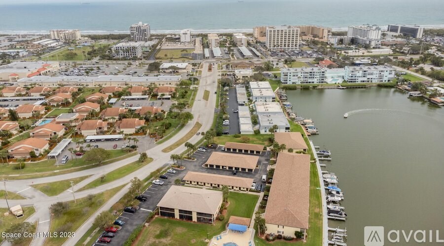 A bird's eye view of a marina with boats and buildings.
