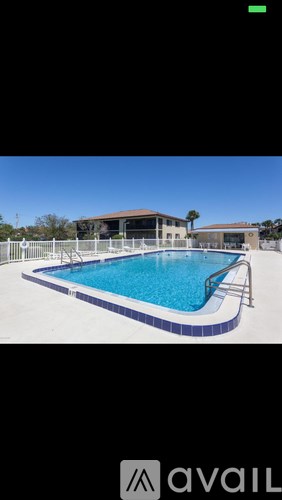 A pool with a blue tiled edge and a metal ladder.