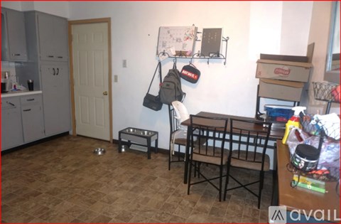 A kitchen with a table and chairs in the middle of the room.