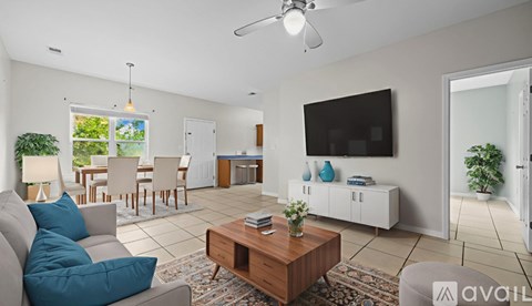 A living room with a grey couch and a wooden coffee table.