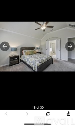 A bedroom with a bed, dresser, and ceiling fan.