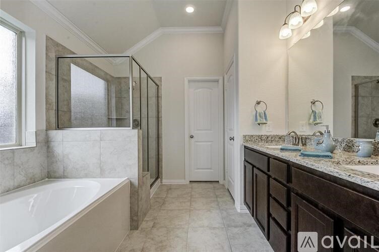A bathroom with a tub, sink, and mirror.