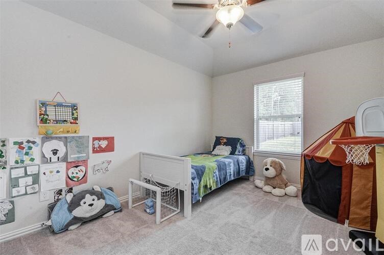 A bedroom with a bed, a crib, and a playpen.