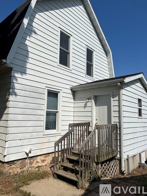 A white house with a grey front porch.