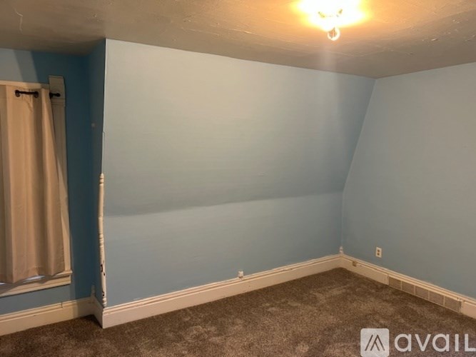 A room with blue walls and a carpeted floor.
