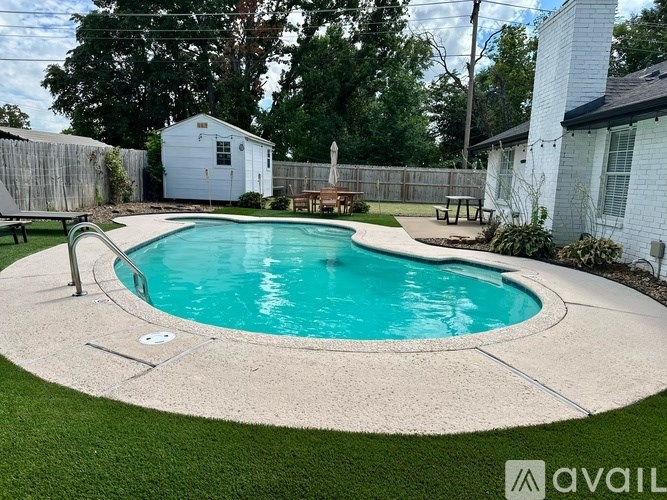 A small residential pool surrounded by a concrete border.